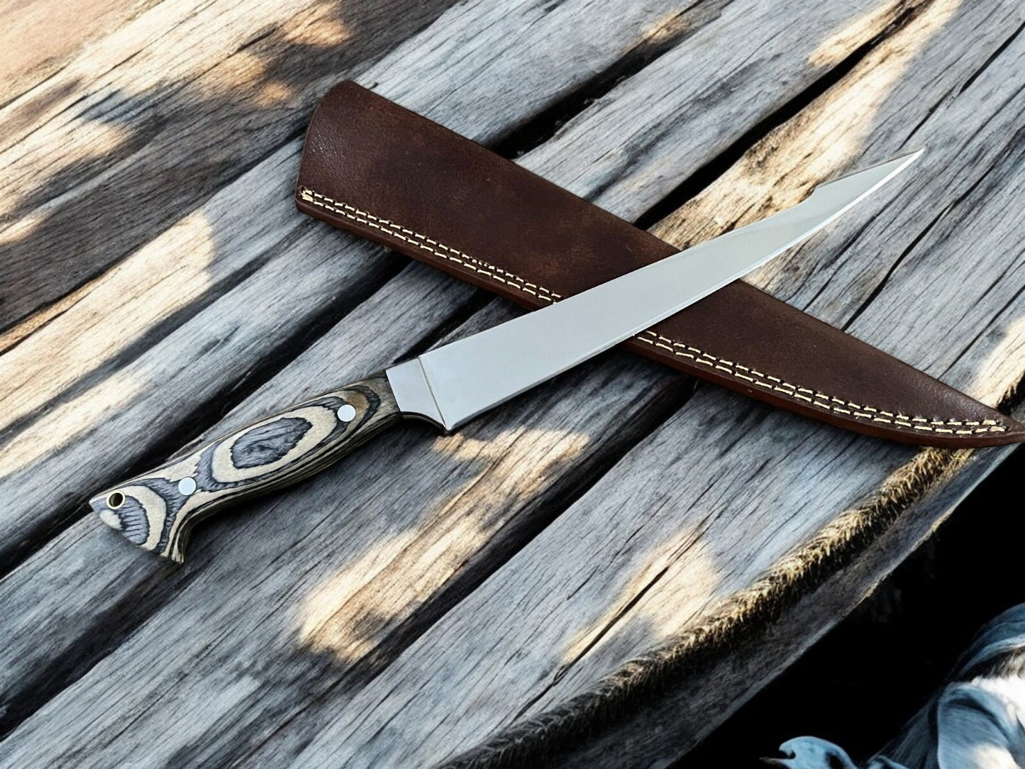 Pakka wood handle and steel bolster detail on fillet knife
