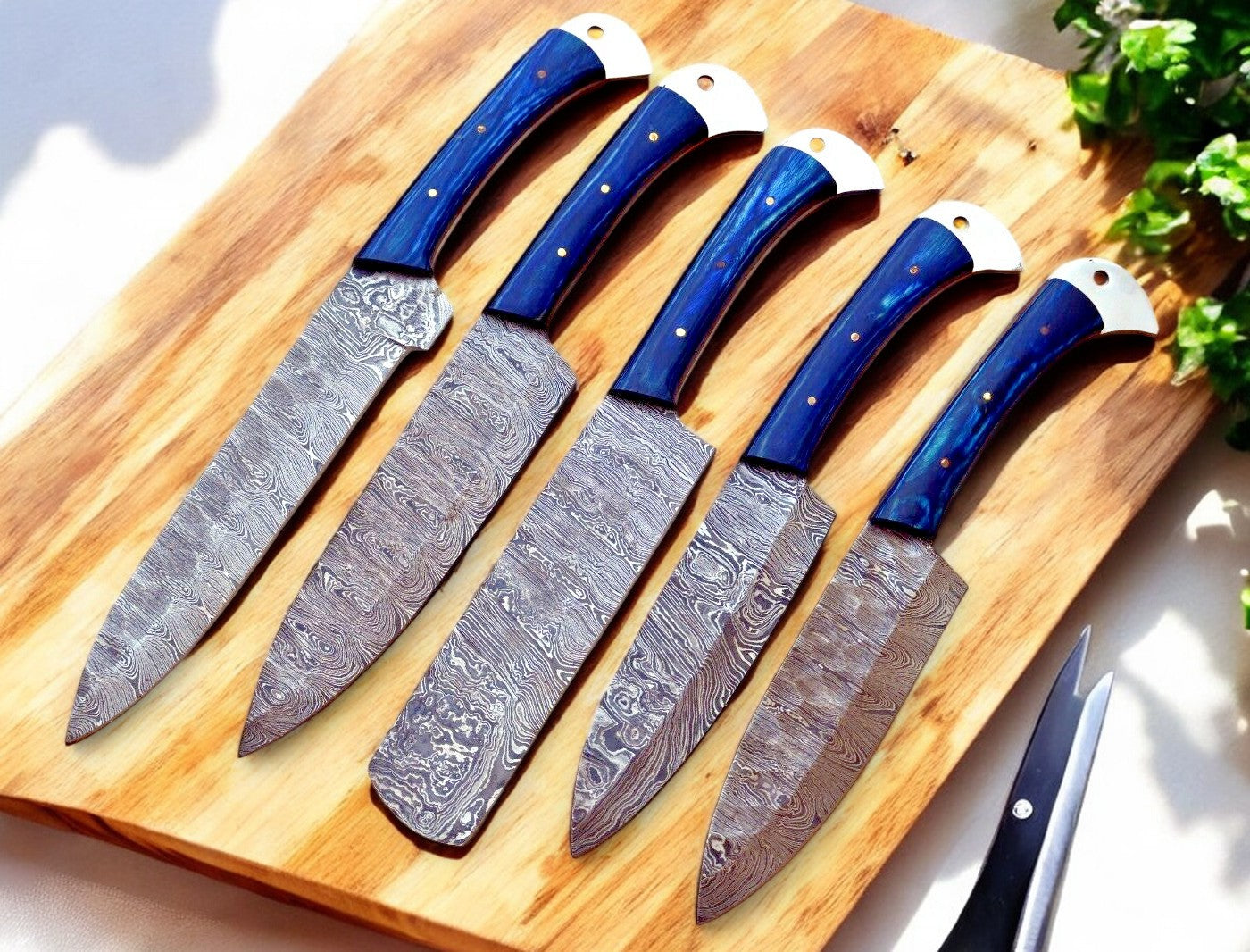 Exotic wood handles of the Damascus knife set in vibrant hues.
