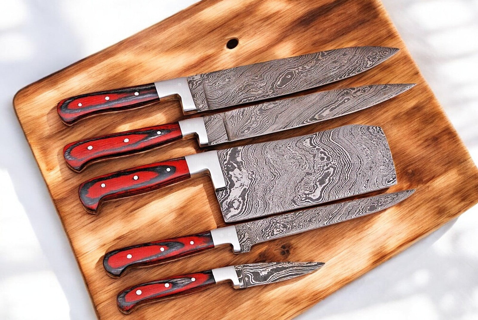 Close-up of the Damascus steel blade with intricate patterns.
