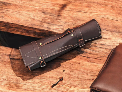 Leather roll showcasing a complete set of handmade kitchen knives.
