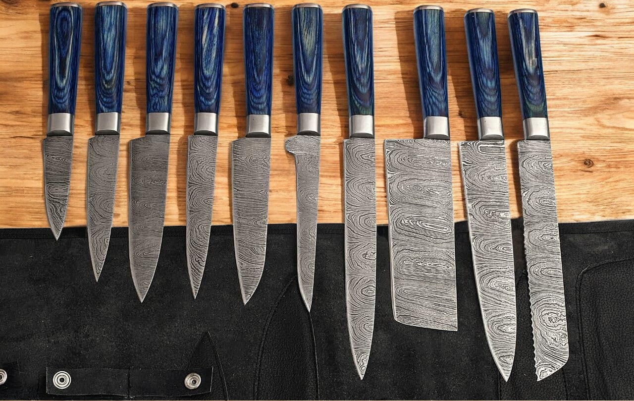 Knife set ranging from 13 inches to 8 inches laid out on a counter.
