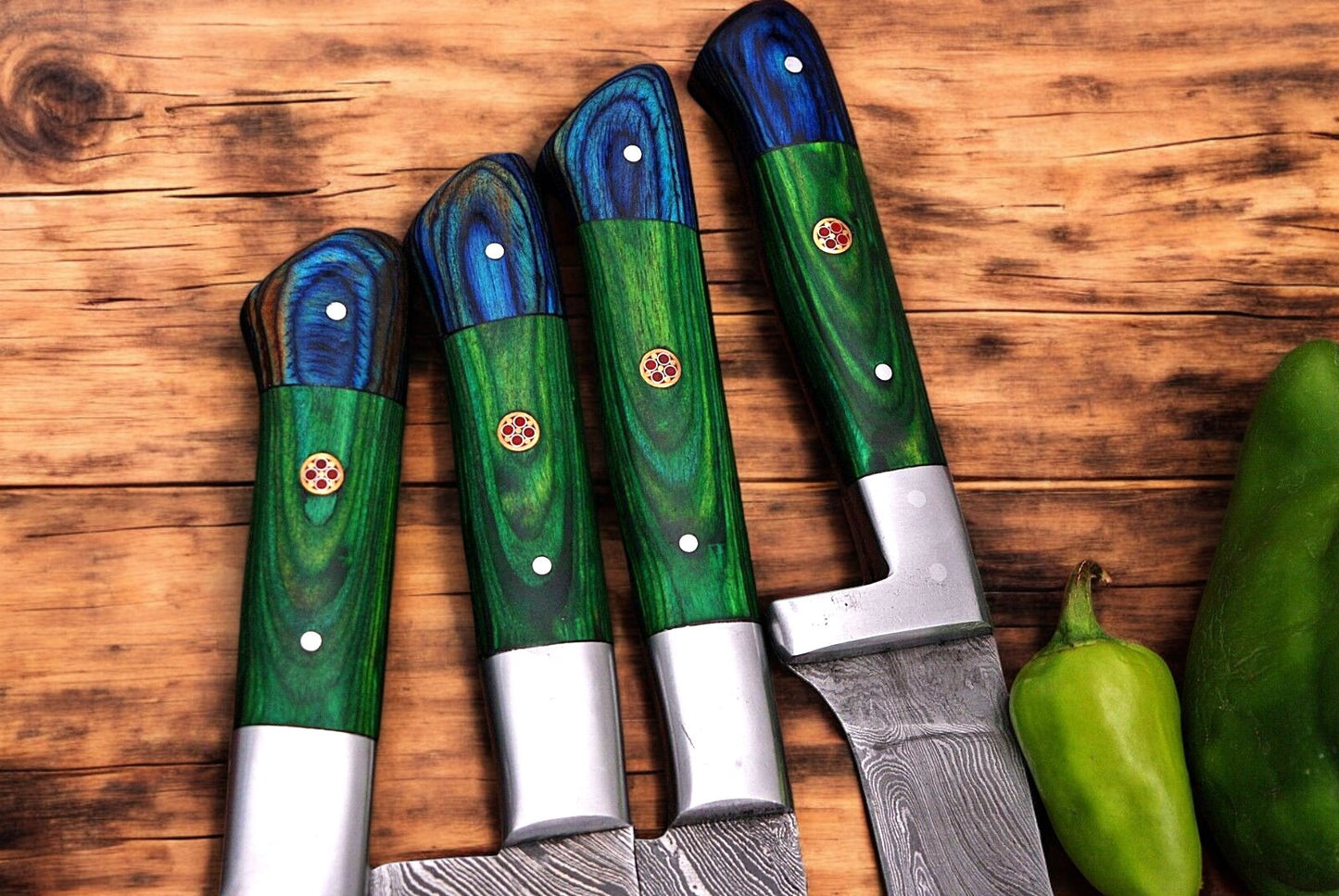 Exotic wood handle chef knife with a steel bolster close-up.
