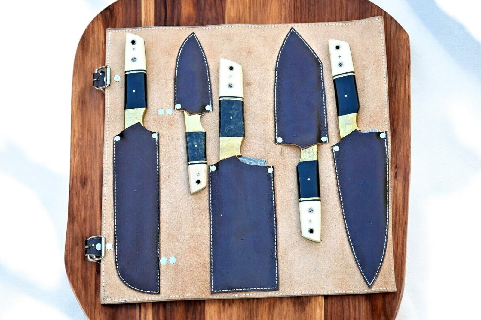 Full set of chef knives arranged in a leather roll
