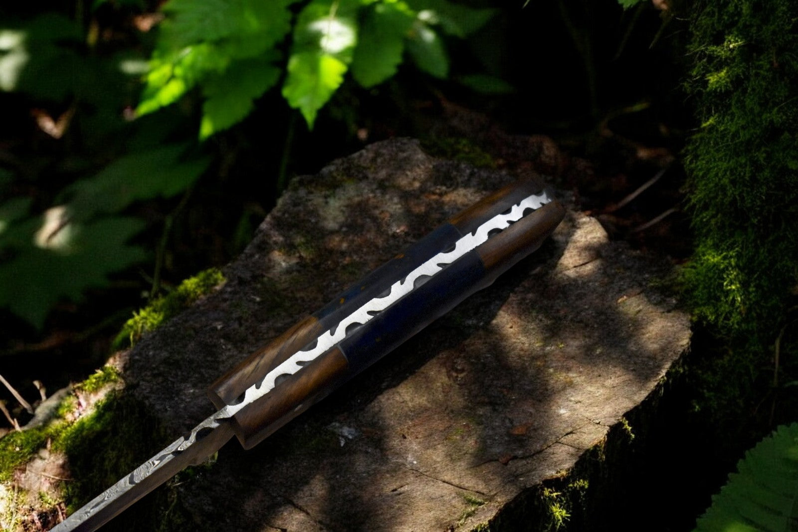 Close-up of Damascus steel blade on custom skinning knife.
