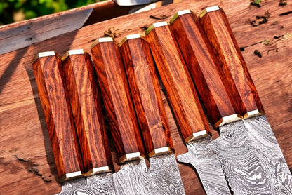 Elegant rosewood handle of the Damascus kitchen knife.
