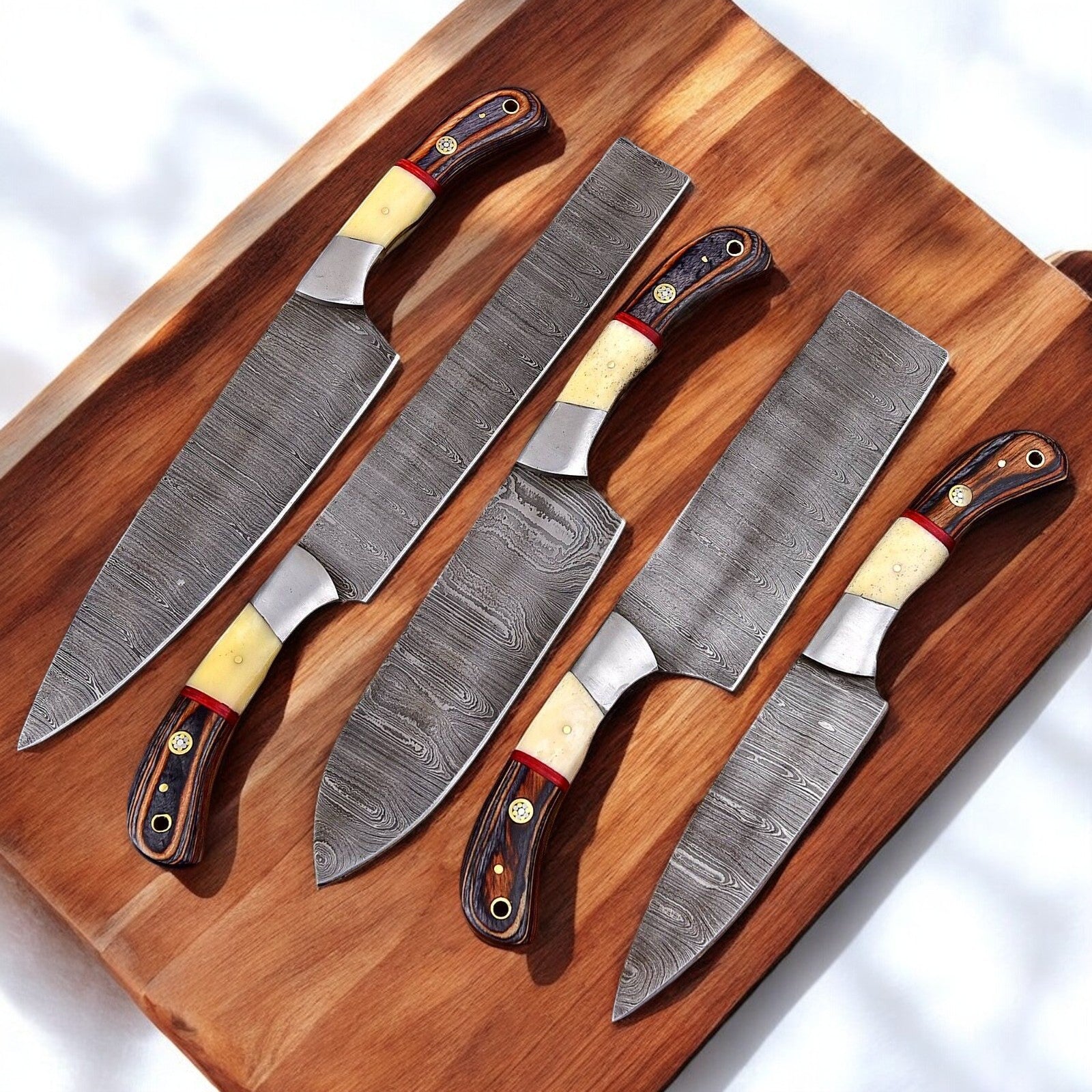 Handcrafted custom kitchen knife set displayed on a cutting board.
