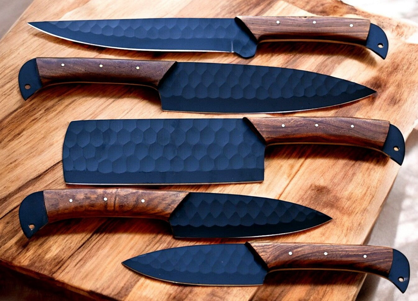 Close-up of Damascus steel blade detailing on kitchen knives.
