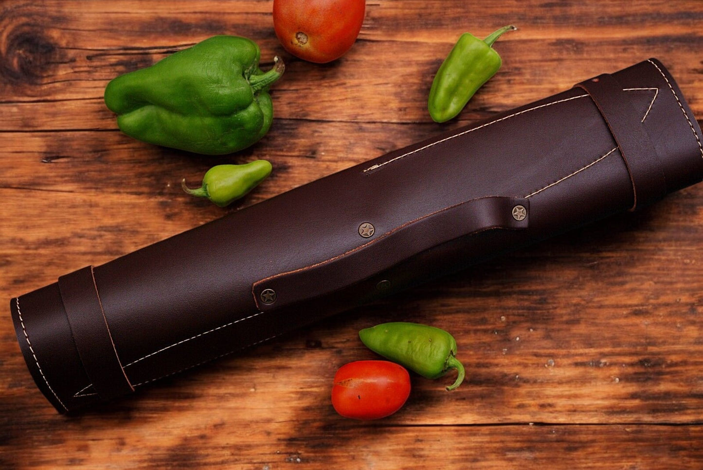 Leather roll open, displaying the custom kitchen knives set inside.
