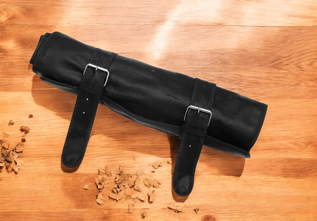 Full view of the professional kitchen knife set in a leather roll.
