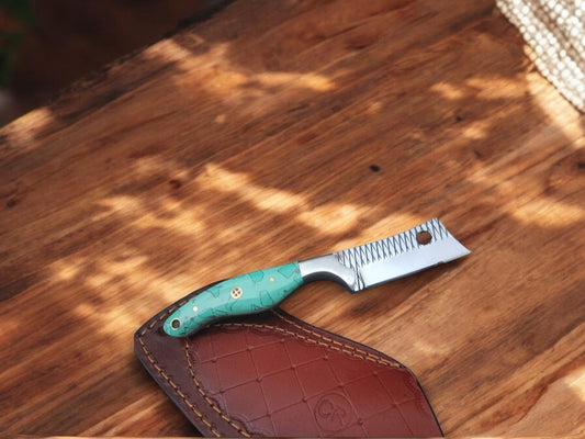 Full view of the handmade bull cutter knife with an epoxy resin handle.
