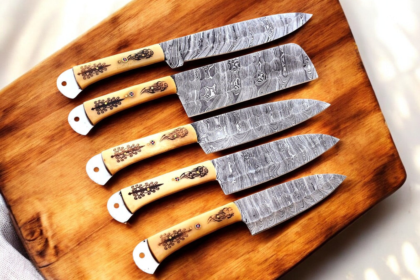 Close-up of Damascus steel blades from the custom kitchen knife set.
