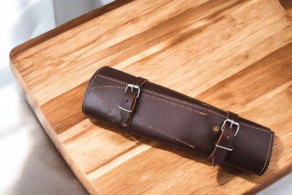 Leather roll for storing Damascus kitchen knives, open and displayed.
