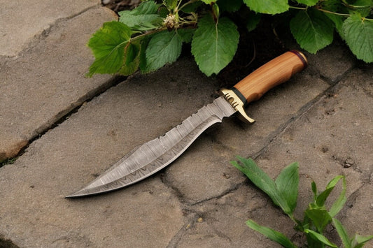 15-inch handmade Bowie knife displayed outdoors
