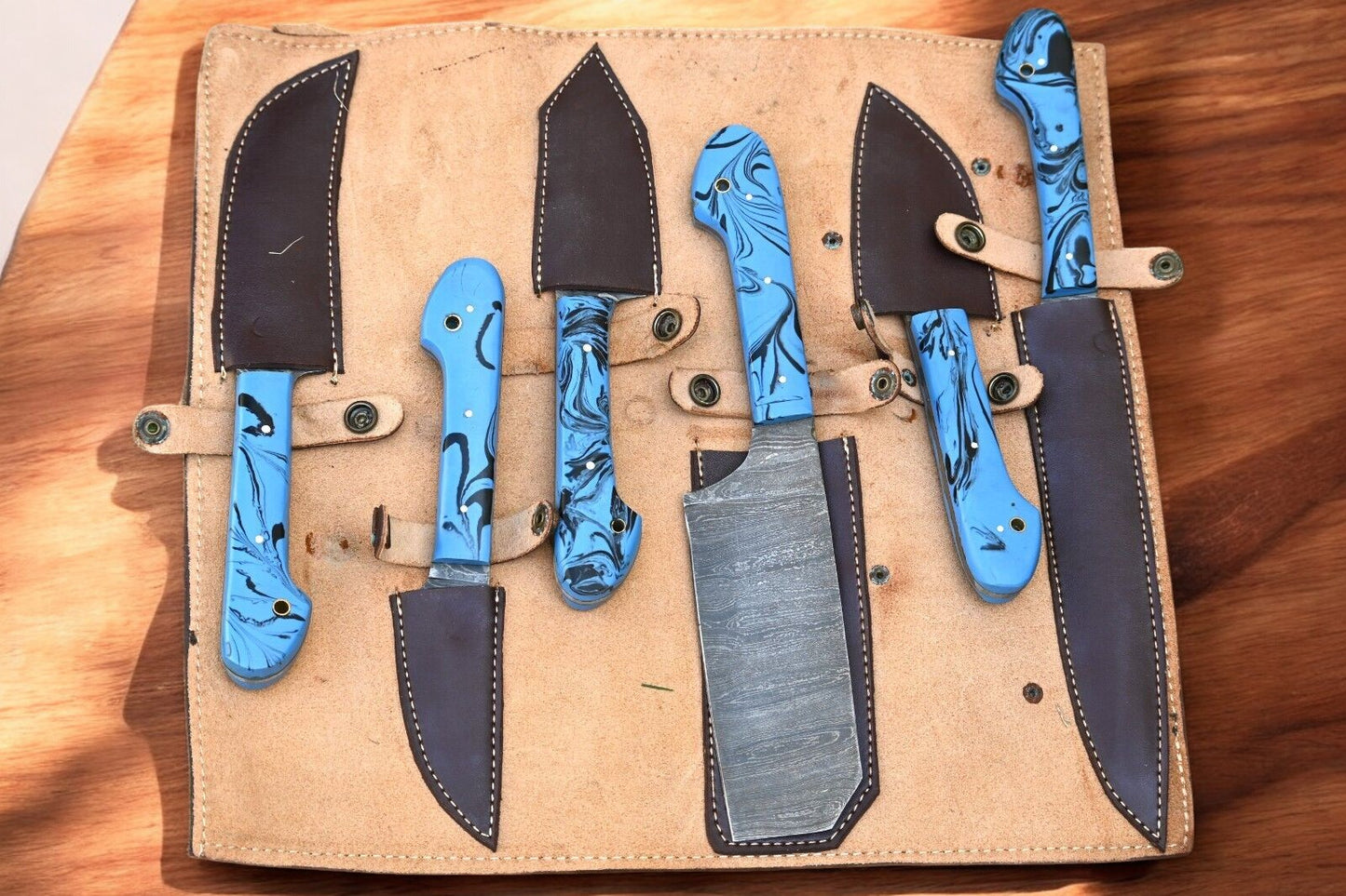 "Professional kitchen knife set displayed in a leather roll"
