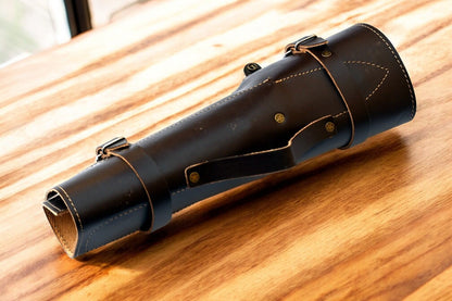 Professional kitchen knife set displayed in a leather roll.
