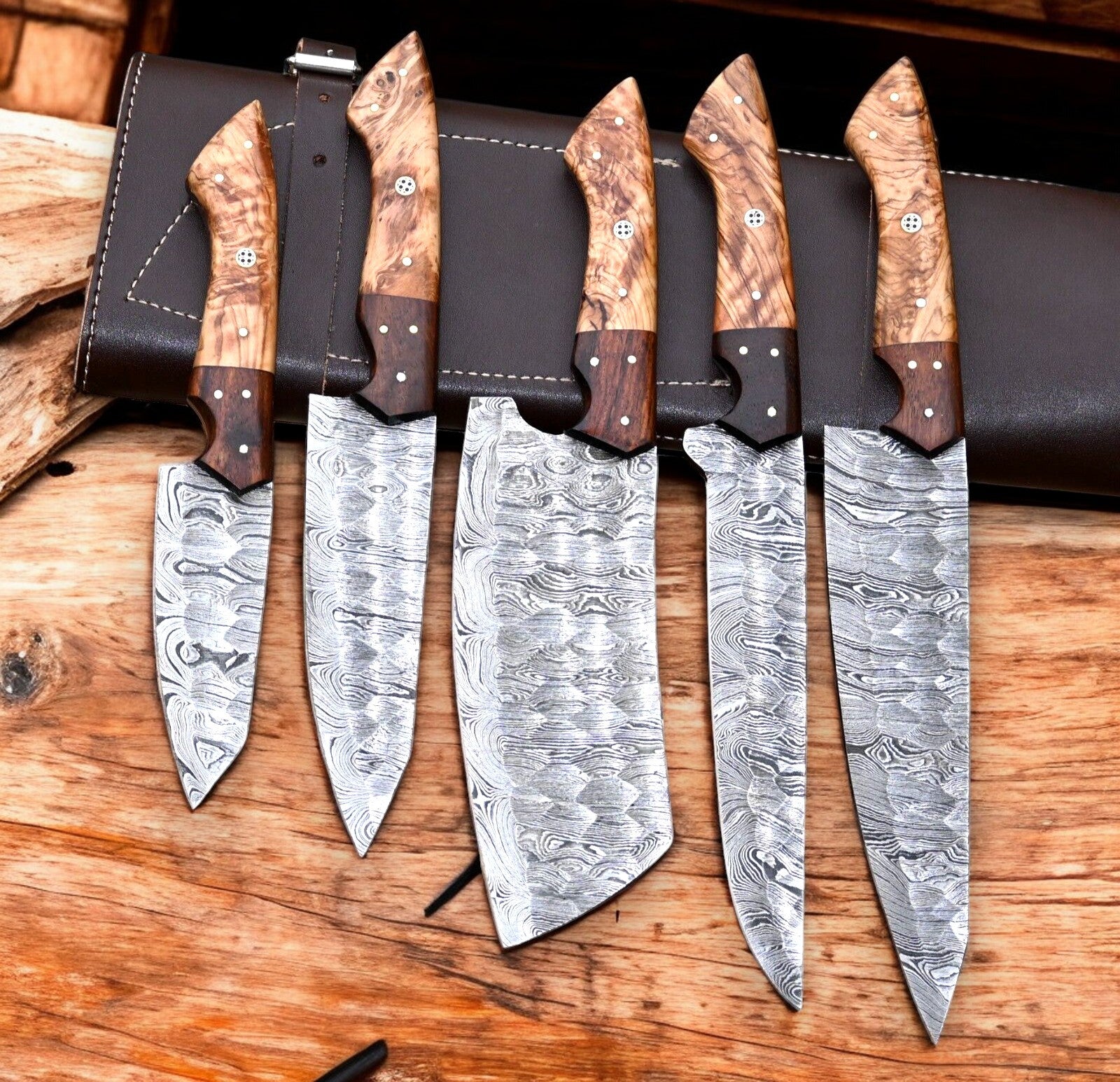 Custom handmade Damascus knife set with leather roll.
