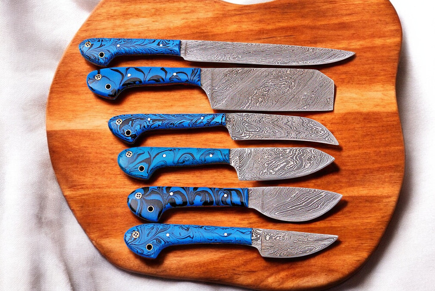 Custom kitchen knife set with Damascus steel blades and epoxy resin handles.
