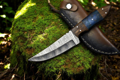 Handmade Damascus steel skinning knife with leather sheath.
