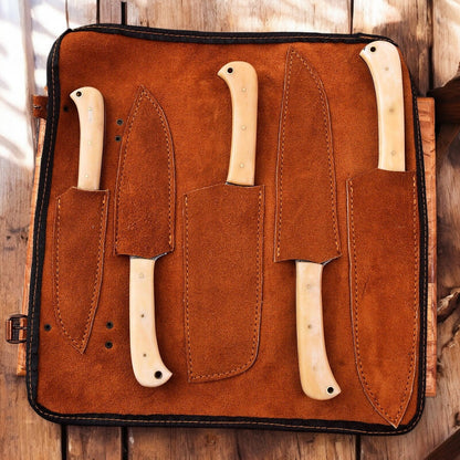 Handmade chef knives with leather roll storage.
